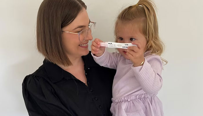 After falling pregnant, Kirsty Bryant shared her positive pregnancy test with her young daughter Violet. — ABC