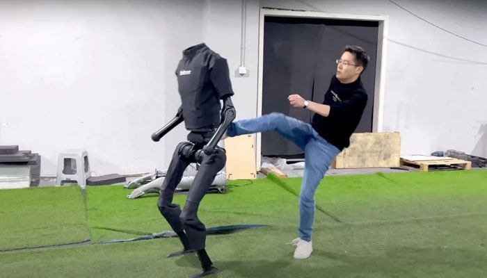 H1 humanoid robot being kicked by a person. — Unitree Robotics