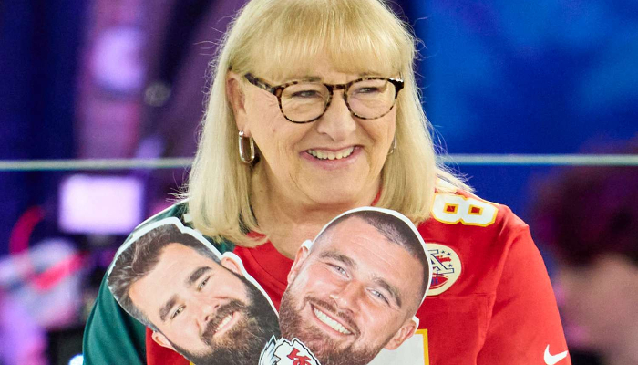 Donna Kelce holding sons handouts