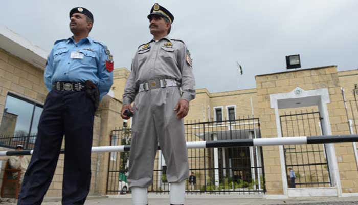 Pakistani policemen stand in front of the Election Commission of Pakistan (ECP) office in Islamabad. — AFP/File