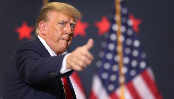 Republican presidential candidate and former US President Donald Trump gestures as he leaves a campaign event on December 19, 2023, in Waterloo, Iowa. — AFP