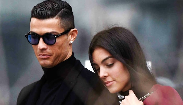 In this file photo taken on January 22, 2019, Cristiano Ronaldo leaves with his Spanish girlfriend Georgina Rodriguez after attending a court hearing for tax evasion in Madrid. — AFP