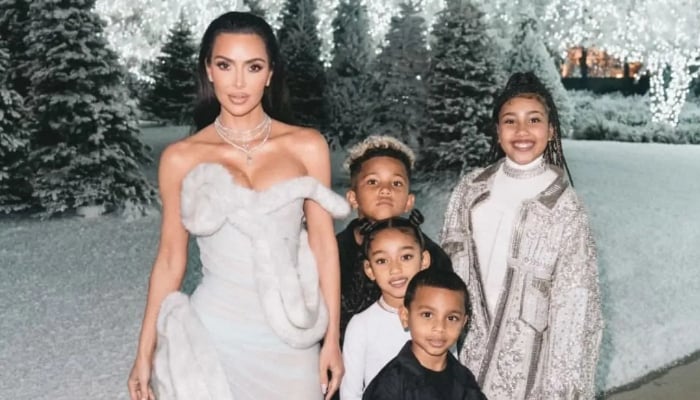 Kim Kardashian posing with kids for Christmas Bash channeling Elsa