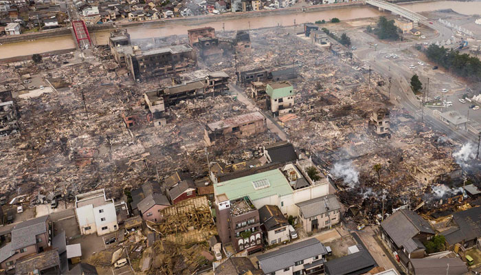 This aerial photo shows smoke rising from an area following a large fire in Wajima, Ishikawa prefecture on January 2, 2024, a day after a major 7.5 magnitude earthquake struck the Noto region in Ishikawa prefecture. — AFP