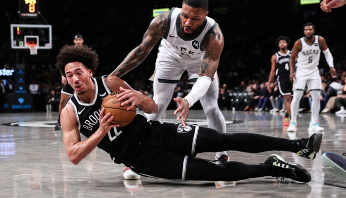 Brooklyns Jalen Wilson grabs the ball from Milwaukees Damian Lillard during a Bucks NBA road victory in December, a game for which the Nets have been fined $100,000 for violating the NBAs Player Participation Policy. — AFP