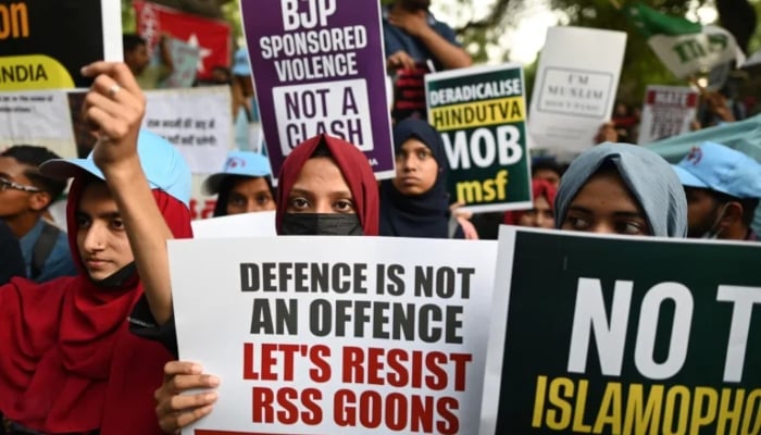 Protesters hold placards during a demonstration against anti-Muslim violence and hate crimes in New Delhi. —AFP