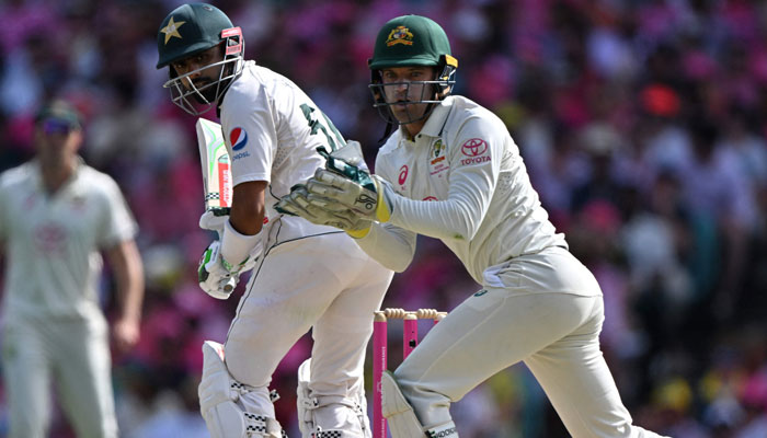 Pakistan´s Babar Azam (left) plays a shot as Australia´s wicketkeeper Alex Carey looks on during day three of the third cricket Test match between Australia and Pakistan at the Sydney Cricket Ground in Sydney on January 5, 2024. — AFP