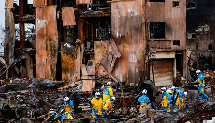 Policemen search for victims in Asaichi-dori street, which burned down due to a fire following an earthquake in Wajima, Ishikawa Prefecture, Japan, January 7, 2024. — Reuters