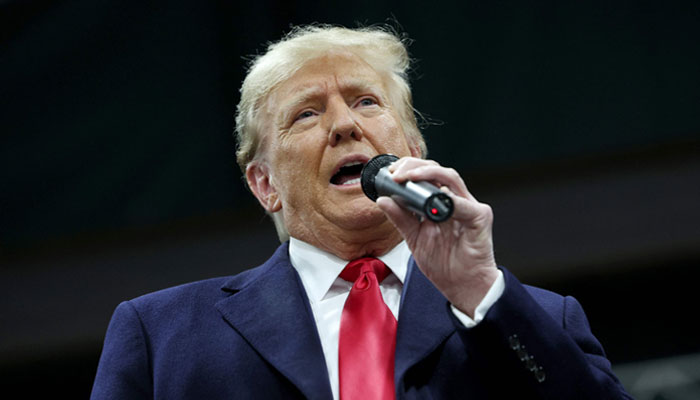 Former president Donald Trump speaks to voters during a visit to a caucus site at the Horizon Event Center on January 15, 2024, in Clive, Iowa. —AFP