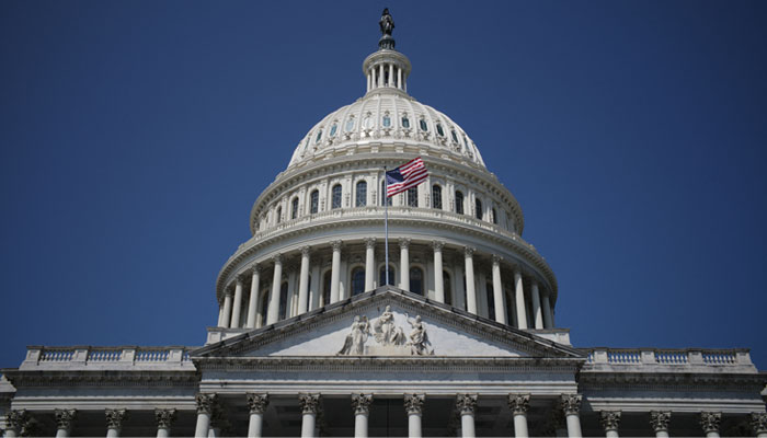 The US national flag flies on the US Capitol in Washington, DC, on August 8, 2021. —AFP