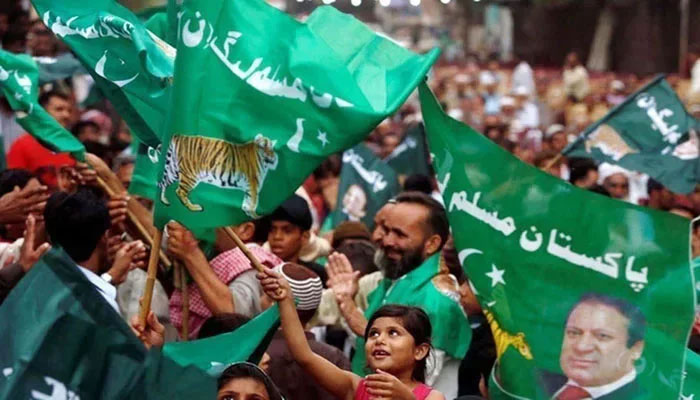 PMLN workers holding flags can be seen in this image. — AFP/File