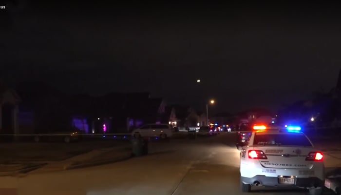 This still shows police vehicles parked in the neighbourhood in Harris County, outside Houston where the shooting took place on January 21, 2024. — KPRC2