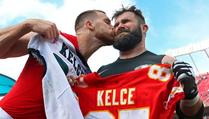 Kansas City Chiefs tight end Travis Kelce (87) kisses Philadelphia Eagles center Jason Kelce (62) after the game at Arrowhead Stadium. —People/file