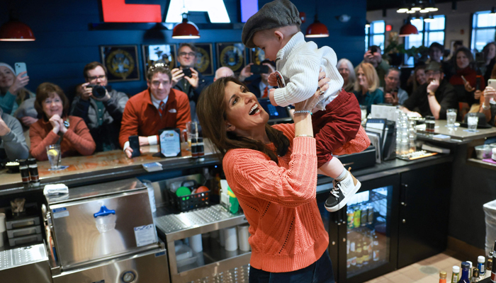 Republican presidential candidate, former UN Ambassador Nikki Haley, holds Arthur Cowette, 16 months, during a meet and greet event at T-BONES on January 22, 2024, in Concord, New Hampshire. — AFP