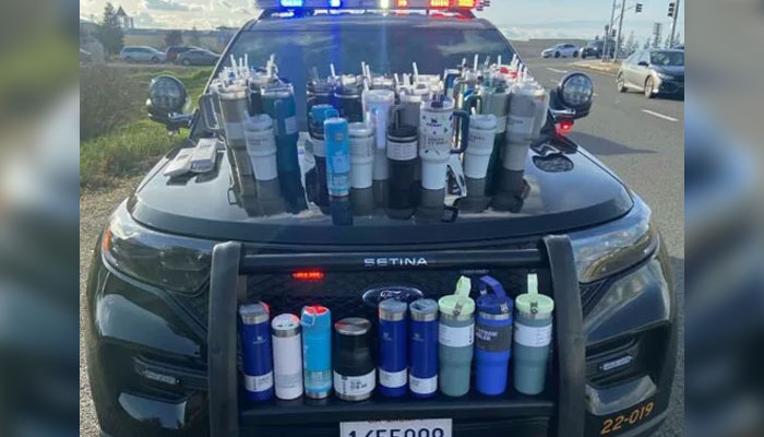 Stanley water bottles that police say were stolen from a Sacramento-area store cover a police cruiser. — Roseville Police Department