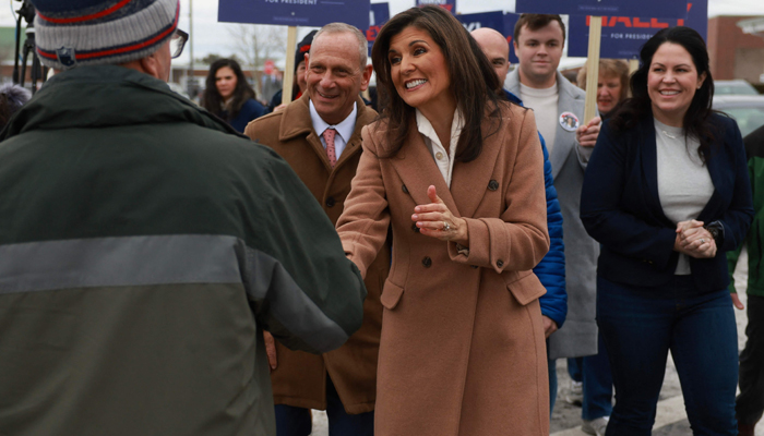 Republican presidential candidate, former UN Ambassador Nikki Haley greets voters as she visits a polling location at Winnacunnet High School on January 23, 2024, in Hampton, New Hampshire. — AFP