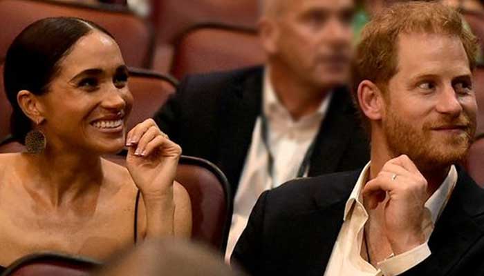 Meghan Markle shows off her missing engagement ring as Harry returns her smile