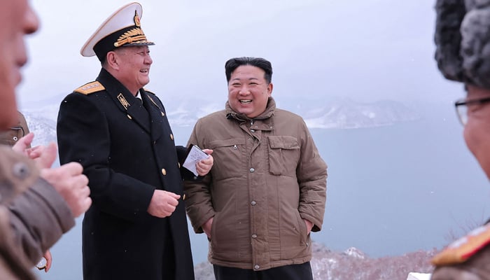This picture taken on January 28, 2024 shows North Korean leader Kim Jong Un (C) inspecting a test-fire of the submarine-launched strategic cruise missile Pulhwasal-3-31 at an undisclosed location in North Korea. — AFP