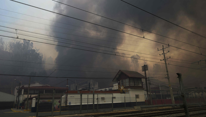 A factory is seen after a forest fire that affected the hills in Quilpue, Viña del Mar, Chile, on February 3, 2024. — AFP