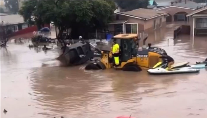 This screenshot shows a San Diego street submerged under water as storm continues. — x/imurpartha
