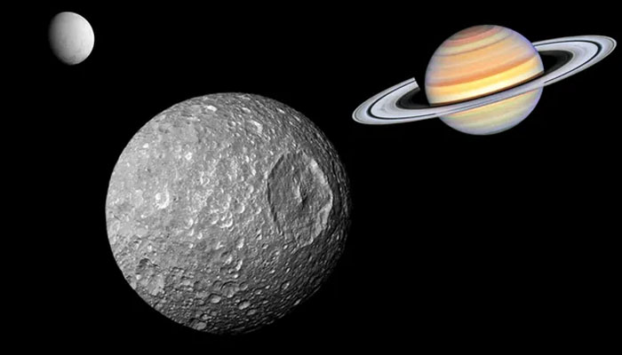 An illustration shows Saturns Death Star moon Mimas with the gas giant and Enceladus in the background. — Nasa/File