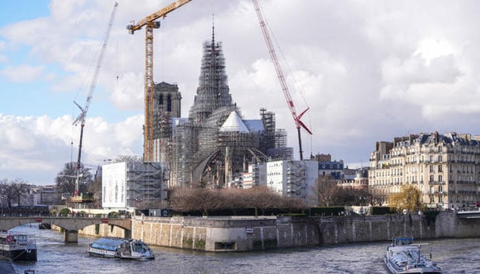 A new golden rooster is seen atop the spire between the two towers of Notre Dame cathedral on Feb. 13 in Paris. — CBS News