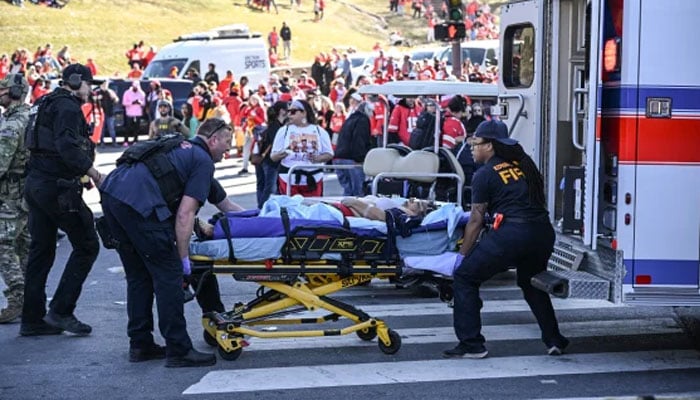 An injured person being loaded into an ambulance by paramedics after shots were fired at the celebration of the Kansas City Chiefs winning Super Bowl LVIII in Kansas City, Missouri, US on February 14, 2024. — AFP