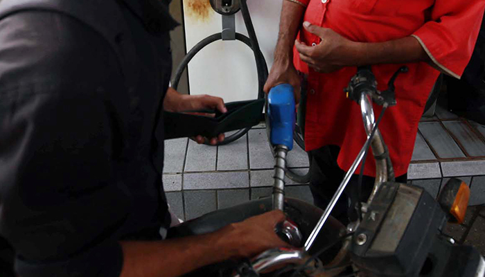 A fuel station worker fills petrol in a motorbike in Karachi, on October 16, 2023. — PPI