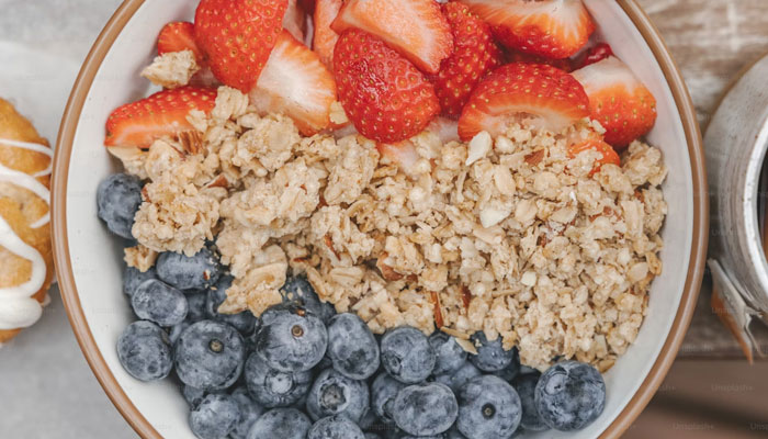 A bowl of oats and berries. — Unsplash