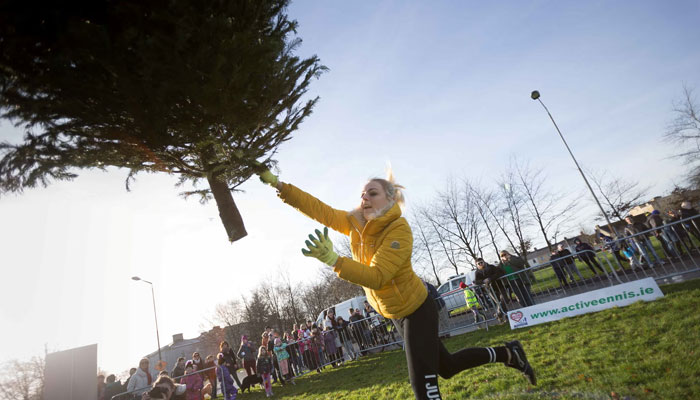 Irish woman Kamila Grabska can be seen throwing a Christmas tree at a competition. — The Guardian/File