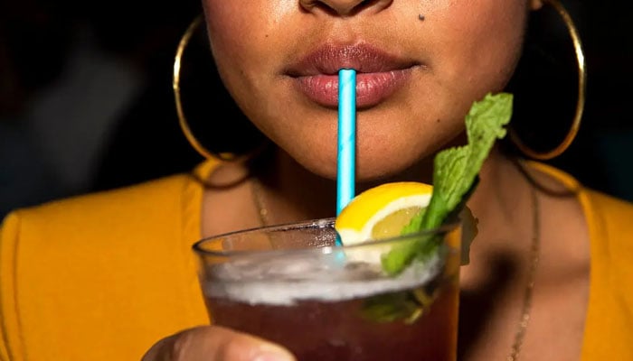 Zulma Umanzor, a server, drinks a cocktail with a paper straw at Freehold in Brooklyn. — Brittainy Newman/File