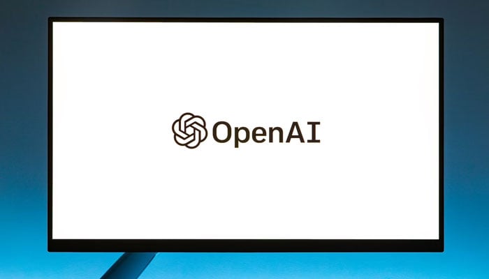 The OpenAI logo is displayed on a TV screen. — Unsplash
