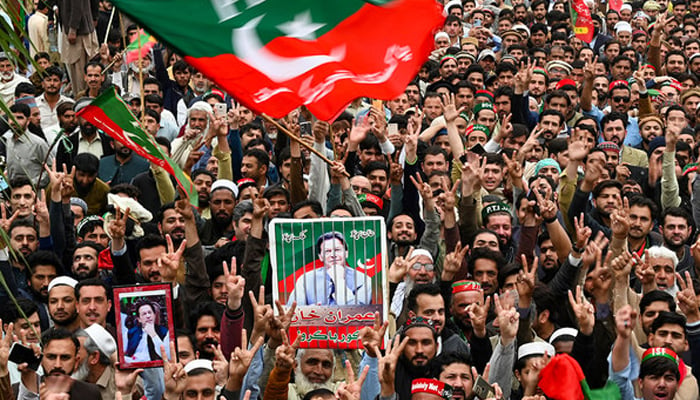 Pakistan Tehreek-e-Insaf (PTI) party supporters hold portraits of Pakistans former prime minister Imran Khan, as they protest against the alleged skewing in Pakistans national election, in Peshawar on March 10, 2024