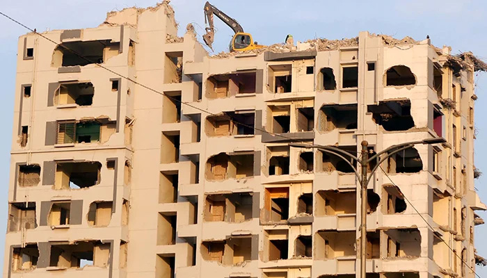 Nasla Towers demolishing works can be seen in progress on Sharea Faisal in Karachi, December 20, 2021.  — PPI/File
