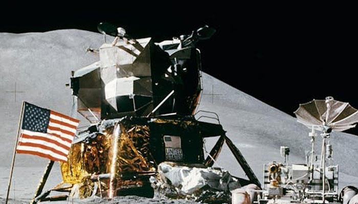 An image of American flag beside landing craft and rover on the moons surface. — Pexels