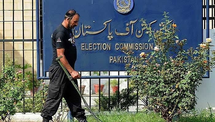 An anti-terrorist force personal uses a metal detector to check the area of the Election Commission of Pakistan (ECP) in Islamabad on August 26, 2008. — AFP