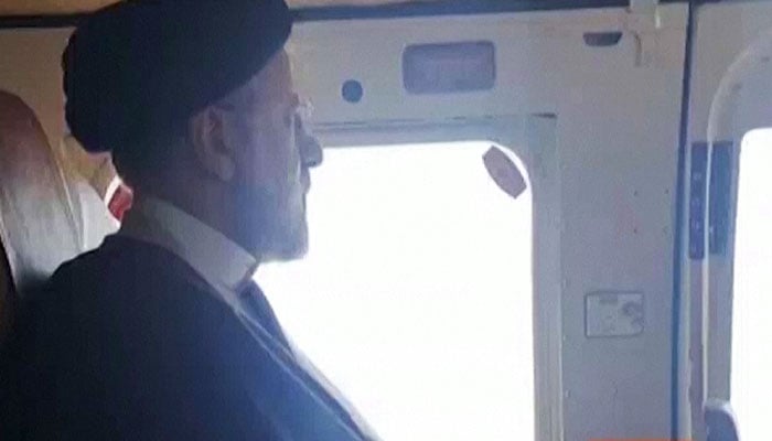 Irans President Ebrahim Raisi on board a helicopter, flying over a dam during a visit to the countrys northwest. — Reuters