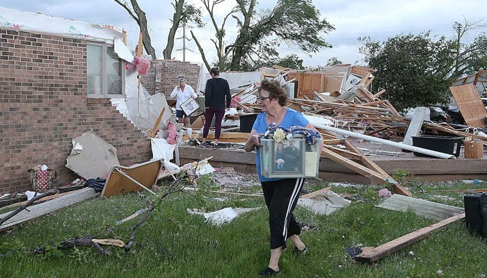 Volunteers clean up after a tornado touched down in Nevada, Iowa, May 21. — Reuters