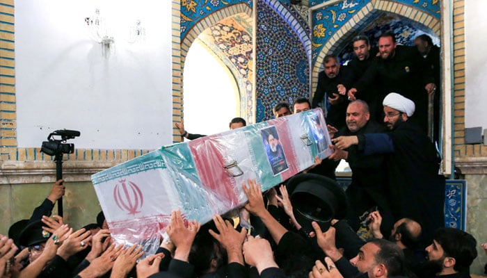 Staff carry the coffin of late Iranian President Ebrahim Raisi during his burial ceremony in the holy shrine of Imam Reza in Mashhad, Iran, May 23, 2024. — Reuters