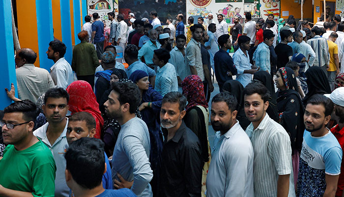 People wait in lines to cast their votes at a polling station during the sixth phase of Indias general election in New Delhi, India on May 25, 2024. — Reuters