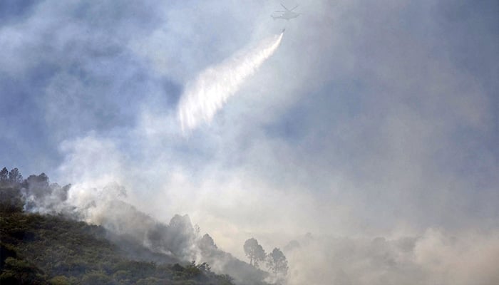Helicopter douses flames on the Margalla Hills in Islamabad, May 28, 2024. — Online