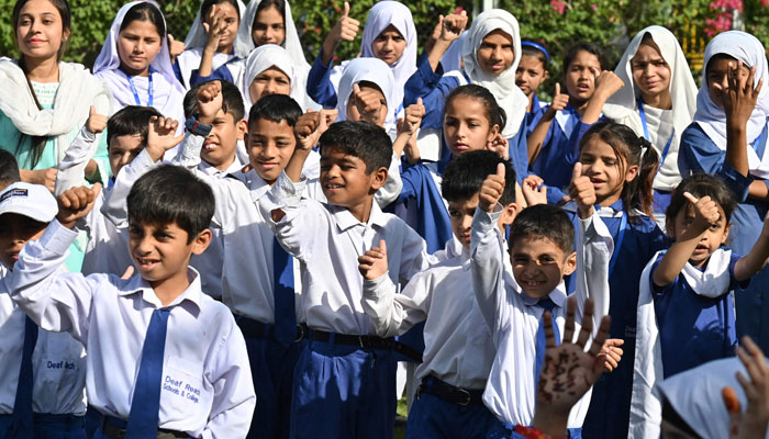 This photograph taken on May 6, 2024 shows hearing impaired students gathering for assembly before the start of their classes at a school in Lahore. — AFP