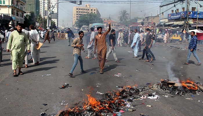 Traders, shopkeepers, and residents block roads and burn tyres and bushes during a protest against electricity loadshedding in Karachi, on May 27, 2024. — PPI