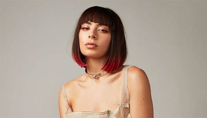 Charli XCX reveals grueling work schedule kept her from visiting father.