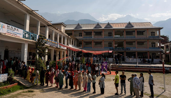 Voters stand in a queue to cast their ballot at a polling station on the seventh and final phase of voting in India´s general election, in Dharamshala on June 1, 2024. — AFP