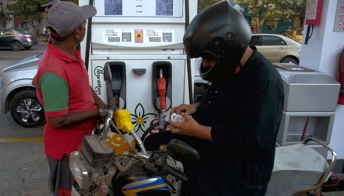 Fuel station worker filling petrol in a motorcycle at a fuel station in Karachi on May 16, 2024. —PPI