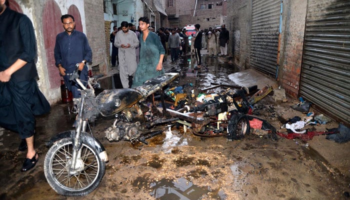 A view of burn motorcycle after gas cylinder explosion in shop at Paretabad. — INP/File