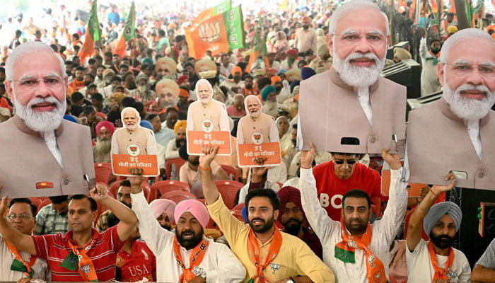 Supporters of the ruling Bharatiya Janta Party (BJP) holding cut-outs of India´s Prime Minister Narendra Modi in Amritsar on May 30, 2024. — AFP
