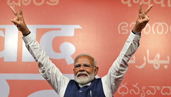 Indias Prime Minister Narendra Modi flashes victory sign during the celebrations after the National Democratic Alliances victory in Indias general election, in New Delhi on June 4, 2024. — AFP