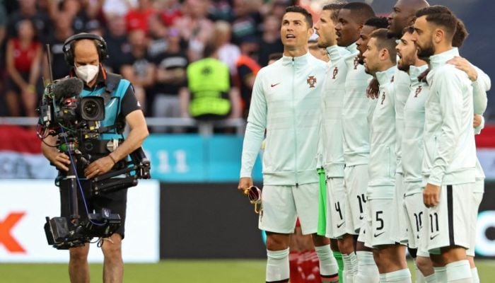 Ronaldo is now famous for standing sideways during Portugals national anthem. — AFP/File